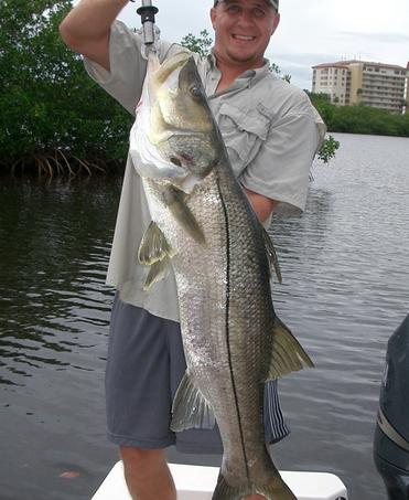 Captain Matt Maloney holding a large snook