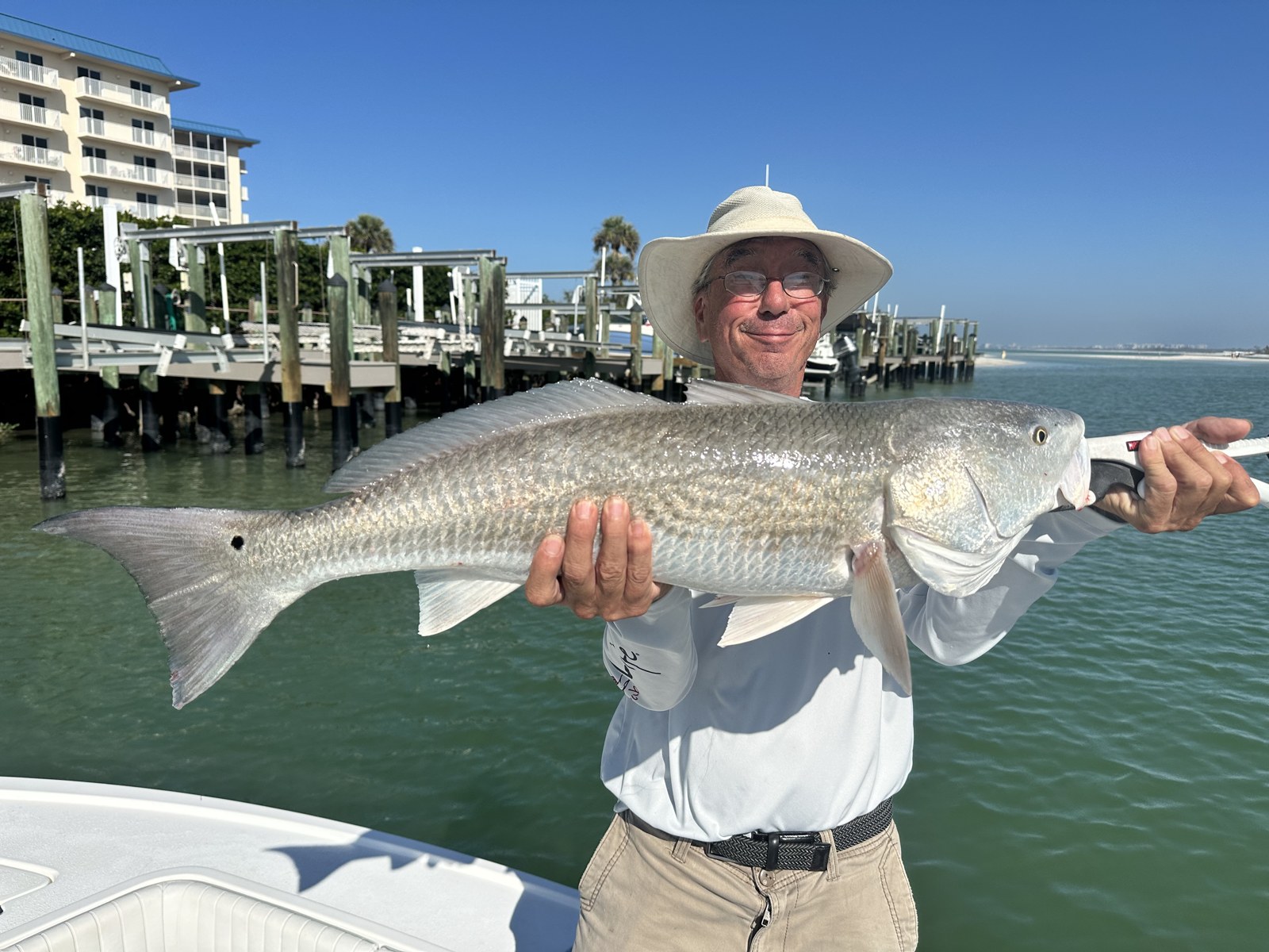 Angler with a bull redfish back at the marina docks