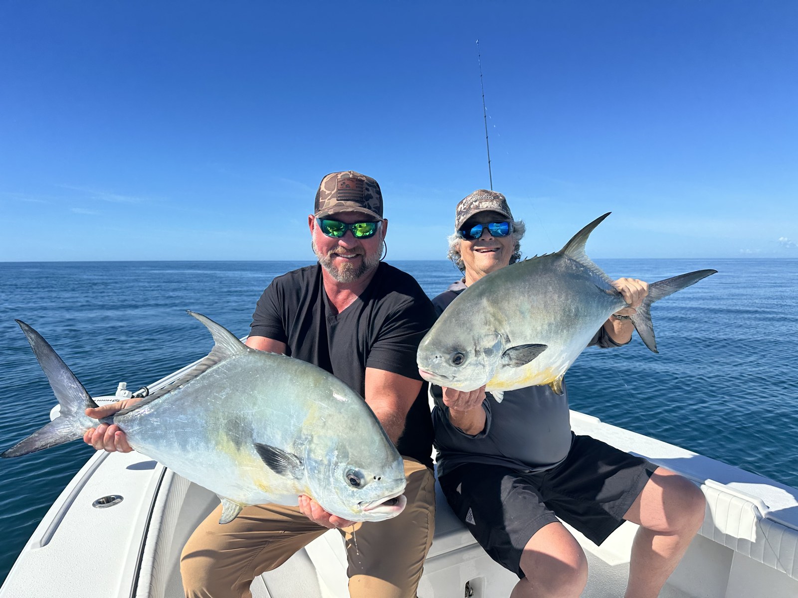 Pair of anglers with two big permit offshore of Naples